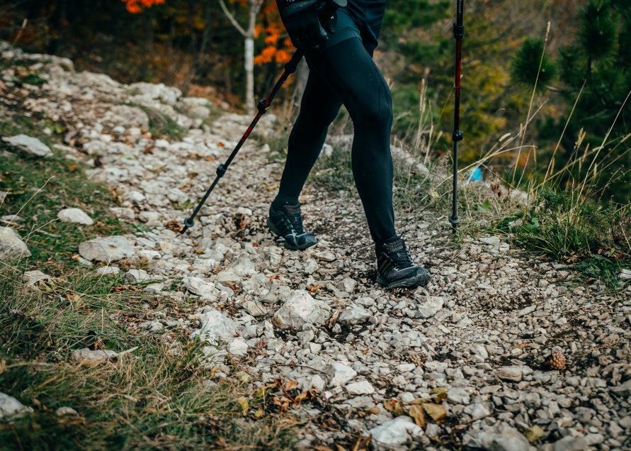 Woman hiking in trail of stones